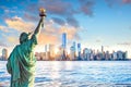 Statue Liberty and New York city skyline at sunset Royalty Free Stock Photo