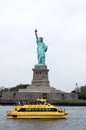 Statue of Liberty and a New York Yellow Water Taxi Royalty Free Stock Photo