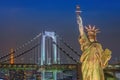 Statue of Liberty and Rainbow bridge, located at Odaiba Tokyo, w Royalty Free Stock Photo