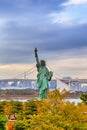 Statue of Liberty and Rainbow Bridge on Odaiba Island in Tokyo, Japan. With Tokyo Tower on Background Royalty Free Stock Photo