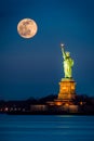 Statue of Liberty and a rising supermoon Royalty Free Stock Photo