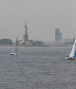 Statue of liberty with sailboats on the foreground