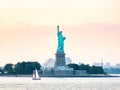 Statue of Liberty seen from the Upper Bay in New York City, United States during pink sunset Royalty Free Stock Photo