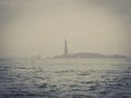 Statue of Liberty Silhouette as Seen from Lower Manhattan, New York City on a Foggy Day of Winter Royalty Free Stock Photo