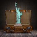 Statue of liberty and vintage suitcase. Travel and tourism to NY New York city and USA concept Royalty Free Stock Photo