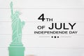 Statue of liberty on white wooden table with the text 4th of July,Independence day