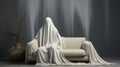A person wrapped in a white sheet sitting on a couch