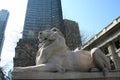 Statue of a lion in cityscape background