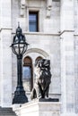 Statue of a lion and a decorative streetlight