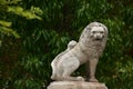 Statue of a lion in front of green plant background in Jerusalem