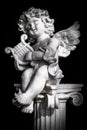 Statue of Little Cupid playing harp Royalty Free Stock Photo
