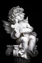 Statue of Little Cupid playing harp Royalty Free Stock Photo