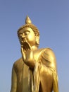 Golden statue of Lord Buddha raising left hand Royalty Free Stock Photo