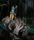 Statue of Lord krishna God playing with snake which came to kill him as in mythology Royalty Free Stock Photo