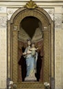 Statue of Madonna standing and holding the Child Jesus in the Basilica of Saint Apollinare Nuovo in Ravena, Italy.