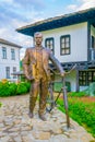 Statue of a man with bicycle in the bulgarian city Troyan...