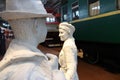 A statue of a man and a girl saying goodbye at the railway station, near train. Royalty Free Stock Photo
