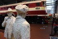 A statue of a man and a girl saying goodbye at the railway station, near train. Royalty Free Stock Photo