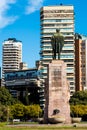 Statue of a man looking to a building in a beautiful day