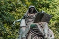 Statue of a man reading a book of historic Bismarck Memorial in the Tiergarten in Berlin, Germany.