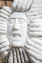 Statue of man's face with gritted teeth