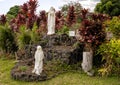 Statue of Mary being adored outside Saint Benedict`s Painted Church on the Big Island, Hawaii. Royalty Free Stock Photo