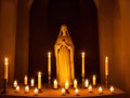 Statue of Mary with Candles Aligned in a Sanctuary, generative ai. Praying Virgin Mary statue at The Church