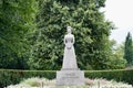 Statue in memory of Queen Maud standing against a background of trees, at the daytime Royalty Free Stock Photo