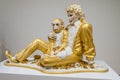 Statue of Michael Jackson in golden costume and a monkey on his knees