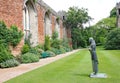 A statue of a monk n the grounds of Wells Cathedral in Somerset, England