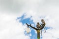 Statue of a monkey family on lamp post on blue sky. Royalty Free Stock Photo