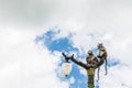 Statue of a monkey family on lamp post on blue sky. Royalty Free Stock Photo