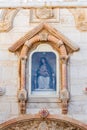 Statue of the Mother of God of a lactating baby in a niche above the entrance to the grotto of the Milk Grotto Church in Bethlehem