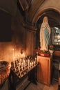 Statue mother virgin mary praying and candlelight altar in christian chruch