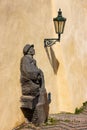 Statue of a musician on the stairs and a lantern with a shadow at Prague Castle Royalty Free Stock Photo