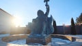 Statue of Neptune in fountain holding a trident in left hand and seashell in other one against blue sky in winter sunny Royalty Free Stock Photo