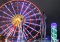 Statue of Nino and Ali at night on the carousel background and alphabetic tower. Batumi,Georgia at august of 2018 Royalty Free Stock Photo