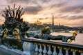 The statue of a nymph ornamenting the Pont Alexandre III in Paris, with the Eiffel tower in the background at sunset Royalty Free Stock Photo