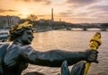 The statue of a nymph ornamenting the Pont Alexandre III in Paris, with the Eiffel tower in the background at sunset Royalty Free Stock Photo