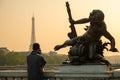 Statue of Nymphs with locks on Alexandre III bridge with Eiffel Tower in the background at sunset time in Paris Royalty Free Stock Photo