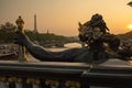 Statue of Nymphs with locks on Alexandre III bridge with Eiffel Tower in the background at sunset time in Paris Royalty Free Stock Photo