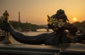 Statue of Nymphs with locks on Alexandre III bridge with Eiffel Tower in the background at sunset time in Paris Royalty Free Stock Photo