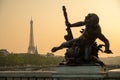 Statue of Nymphs with locks on Alexandre III bridge with Eiffel Tower in the background at sunset time in Paris Royalty Free Stock Photo