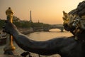 Statue of Nymphs with locks on Alexandre III bridge with Eiffel Tower in the background at sunset time in Paris Royalty Free Stock Photo