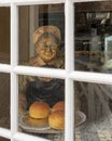 Statue old woman with a plate of three cakes in Piriquita, a family bakery founded in 1862 in Sintra, Portugal.