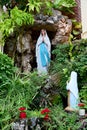 Statue of Our lady of grace virgin Mary view with natural background in the rock cave at Thailand. selective focus.