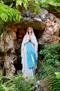 Statue of Our lady of grace virgin Mary view with natural background in the rock cave at Thailand. selective focus. Royalty Free Stock Photo