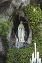 Statue of Our Lady of Immaculate Conception with a rosary in the Grotto of Massabielle in Lourdes Royalty Free Stock Photo