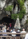 Statue of Our Lady of Immaculate Conception with a rosary in the Grotto of Massabielle in Lourdes Royalty Free Stock Photo