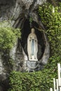 Statue of Our Lady of Immaculate Conception with a rosary in the Grotto of Massabielle in Lourdes Royalty Free Stock Photo